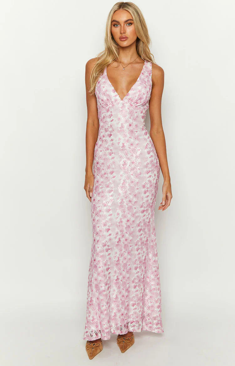 Pink floral lace maxi dress with a deep V-neckline and a fitted silhouette, flowing slightly at the hem