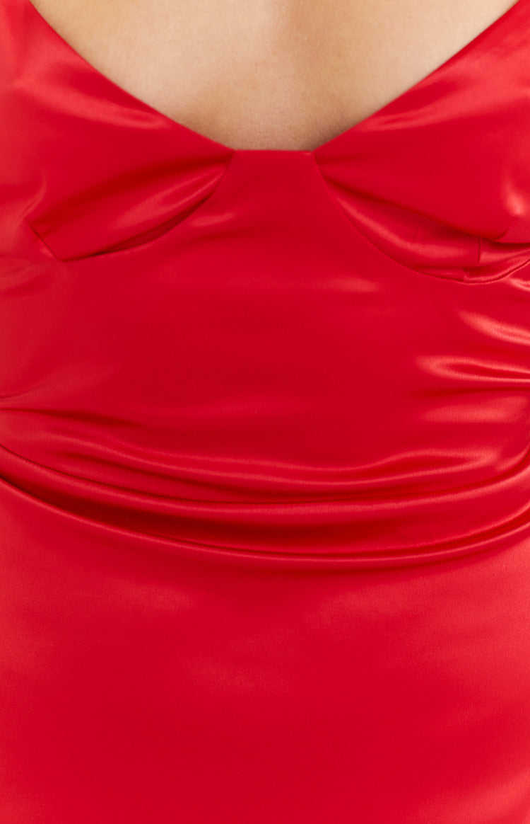 Side view of a red satin maxi dress with spaghetti straps, a low scoop back, and flowing skirt