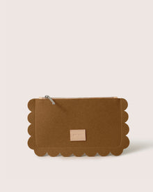 The Graf Lantz Deco Edge Pouch features scalloped edges, a zipper, and a small beige label on the front. Set against a plain white background, this versatile brown clutch adds elegance to any ensemble while securely storing essentials.