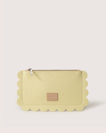 Introducing Graf Lantzs Deco Edge Pouch: a roomy cream clutch with scalloped edges and a zipper closure. It includes a small rectangular label at the bottom center on a sleek, light background—ideal for stylishly organized outings.