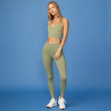 Full View of model wearing the Movement High Rise Legging in Army