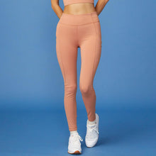 Front View of model wearing the Movement High Rise Legging in Faded Rust