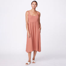 Front view of model wearing the gauze sleeveless maxi dress in faded rust.