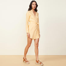 Front view of model wearing the linen mini dress in sand.