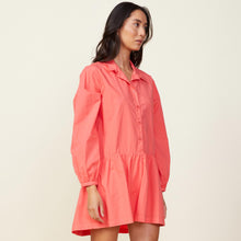 Side view of model wearing the poplin easy shirt dress in watermelon.