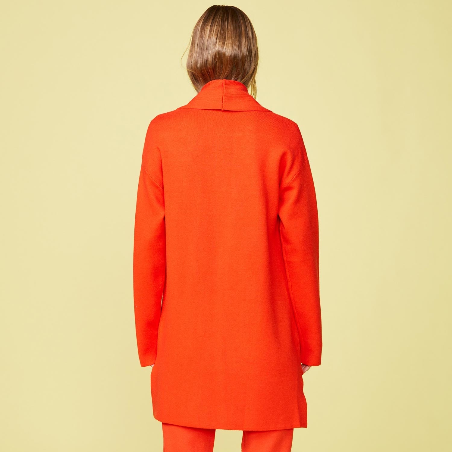 Back view of model wearing the Supersoft Sweater Knit Cardigan in Electric Coral.