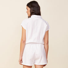 Back view of model wearing the cotton twill pocket romper in white.