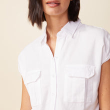 Detail view of model wearing the cotton twill pocket romper in white.