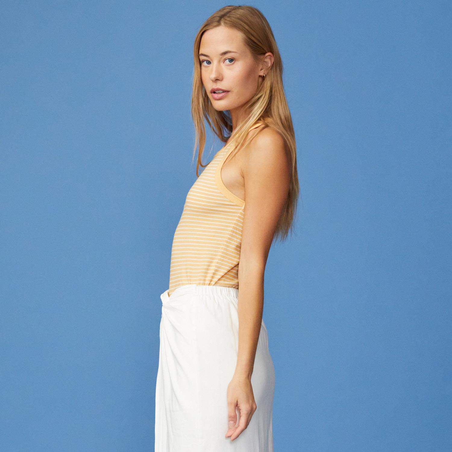 Side View of model wearing the Stripe Narrow Tank in Sand