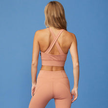 Back View of model wearing the Movement Sports Bra in Faded Rust