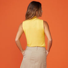 Back view of model wearing the light mock neck tank in sunshine.