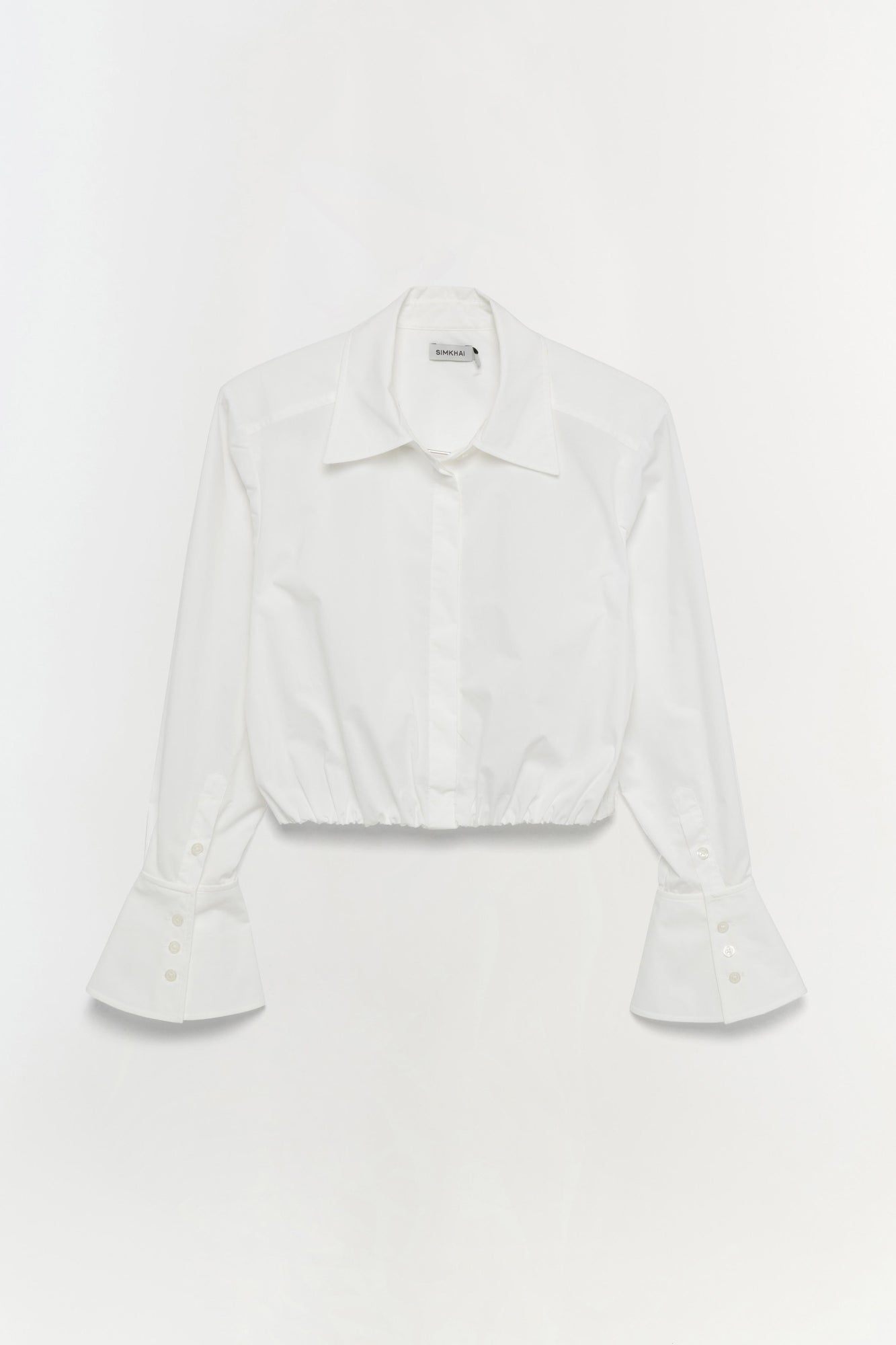 White button-up crop top with collared neckline and flared cuffs with button detailing.