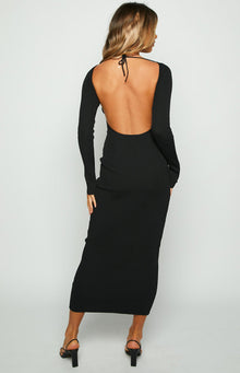 Back view of a black ribbed maxi dress with a low scoop back and long sleeves, tied at the neck