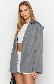 Grey pinstripe oversized blazer with notched lapels and double-breasted front, worn open