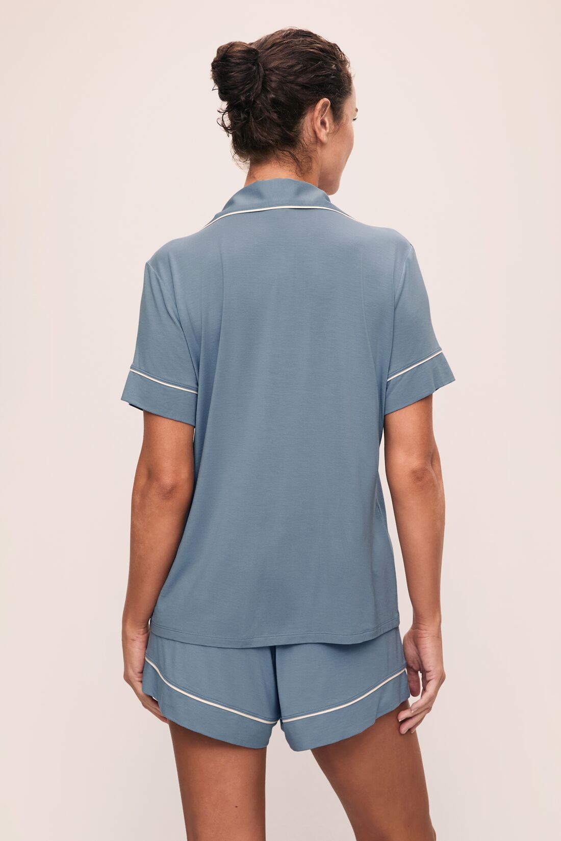 Model is wearing Gisele TENCEL Modal Relaxed Short PJ Set in Faded Denim/Ivory