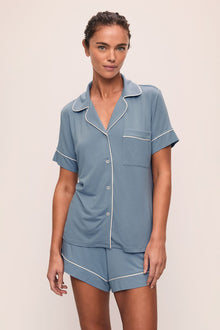 Model is wearing Gisele TENCEL Modal Relaxed Short PJ Set in Faded Denim/Ivory