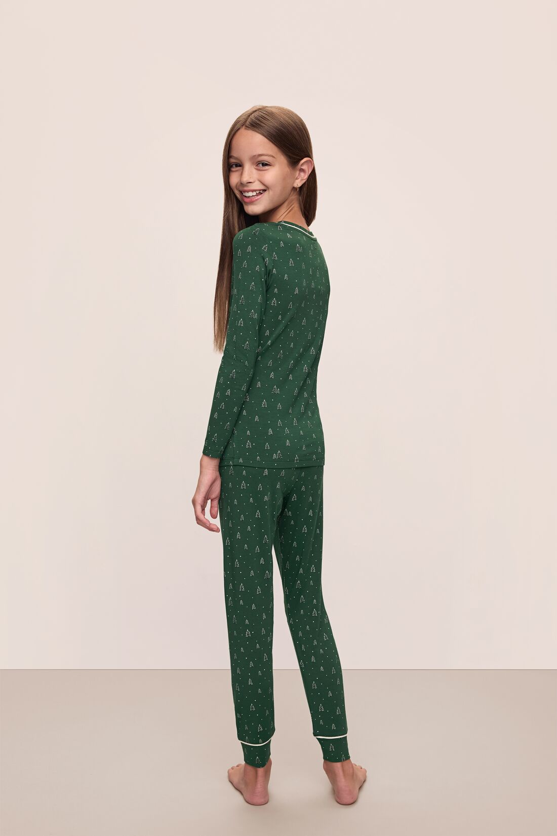 Model wears Kids Printed TENCEL Modal Unisex Long PJ Set in Winterpine Forest Green/Ivory.