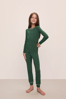 Model wears Kids Printed TENCEL Modal Unisex Long PJ Set in Winterpine Forest Green/Ivory.