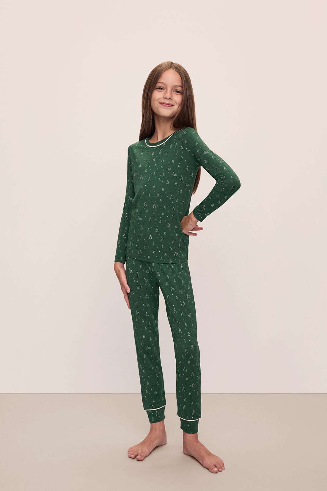 Model wears Kids Printed TENCEL Modal Unisex Long PJ Set in Winterpine Forest Green/Ivory.