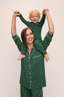 Model wears Kids Printed TENCEL Modal Unisex Long PJ Set in Winterpine Forest Green/Ivory.