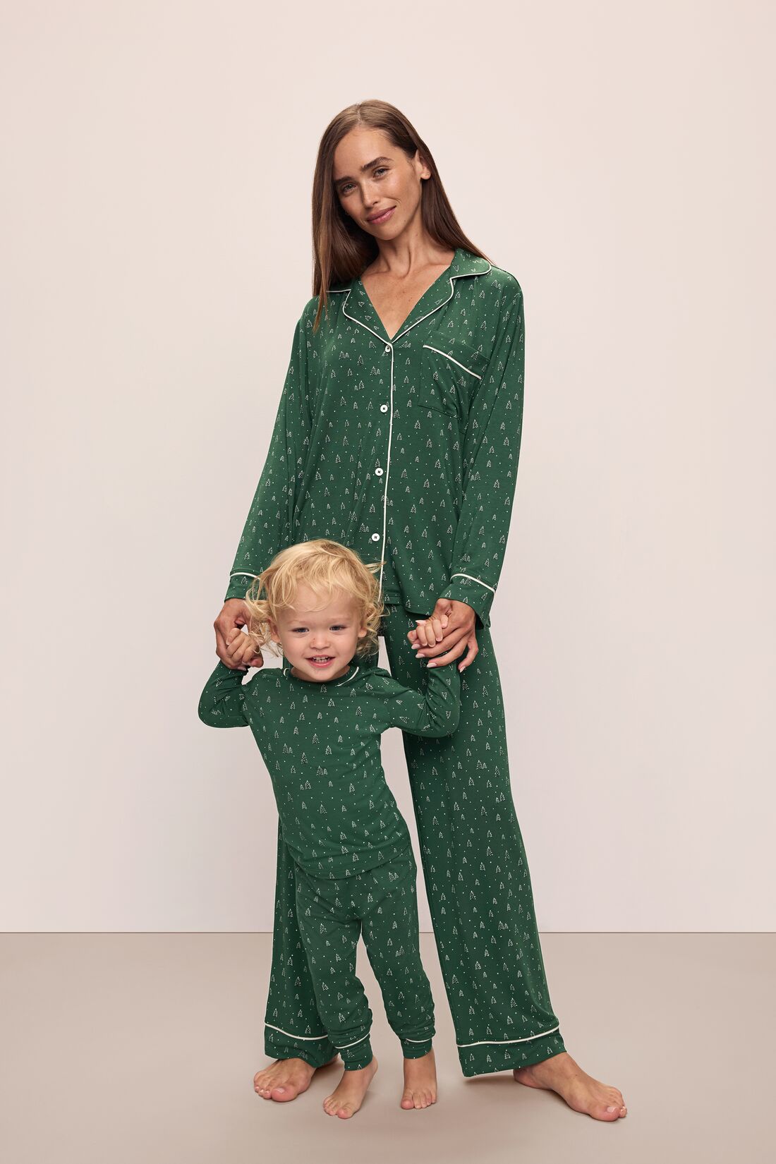 Model wears Kids Printed TENCEL Modal Unisex Long PJ Set in Winterpine Forest Green/Ivory.