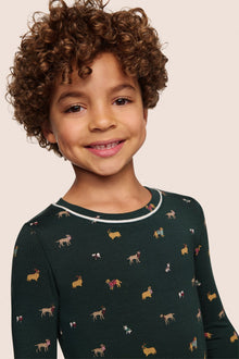 Model is wearing Kids Printed TENCEL Modal Unisex Long PJ Set  in Holiday Dogs Pine/Ivory