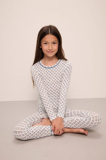 Model wears Kids Printed TENCEL Modal Unisex Long PJ Set in Petite Batik Ivory/Denim Blue.