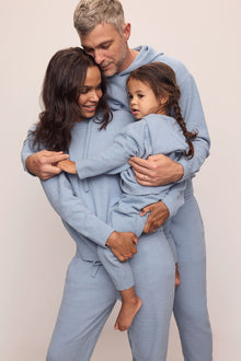 Family image of models in Recycled Boucle Men's Hoodie and Pant, Women's Hoodie and Jogger, and Kid's Hoodie and Jogger Set in Wedgewood