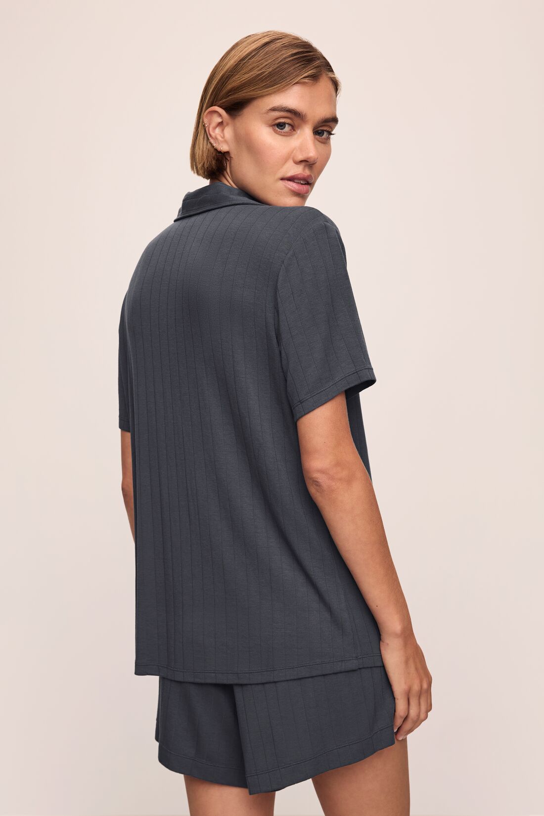 Model wears Gisele TENCEL Modal Rib Relaxed Short PJ Set in Graphite.