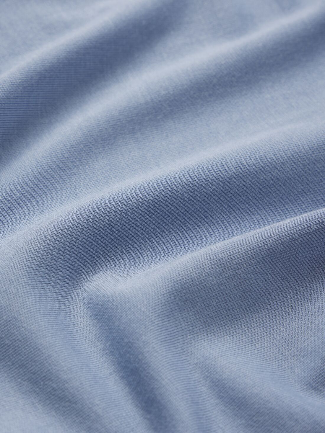 Model wears Kids TENCEL Modal Unisex Long PJ Set in Wedgewood Blue/Ivory.