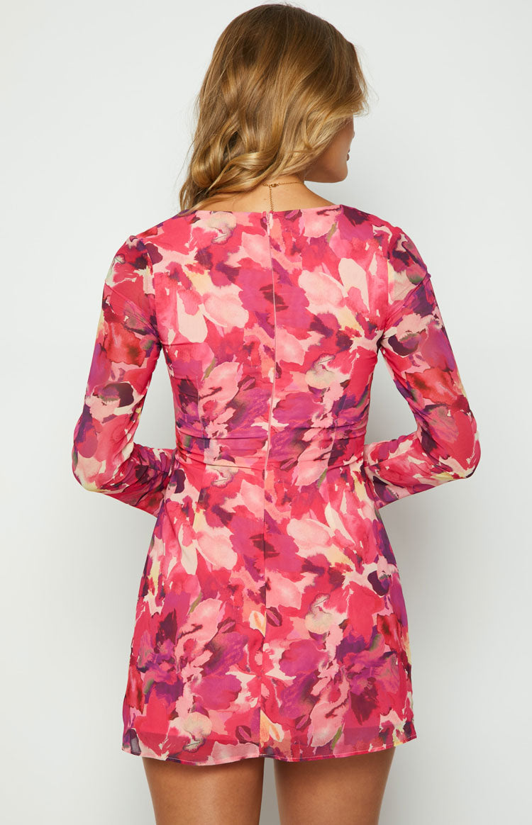Detail shot of the ruched bodice and side tie on the pink floral print dress