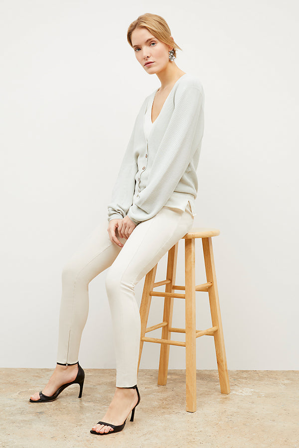 Front image of a woman standing wearing the Curie Pant—Everstretch in Bone | Exclude