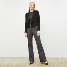 Front image of a woman wearing the horton pant in black and white houndstooth 