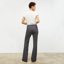 Back image of a woman wearing the horton pant in black and white houndstooth