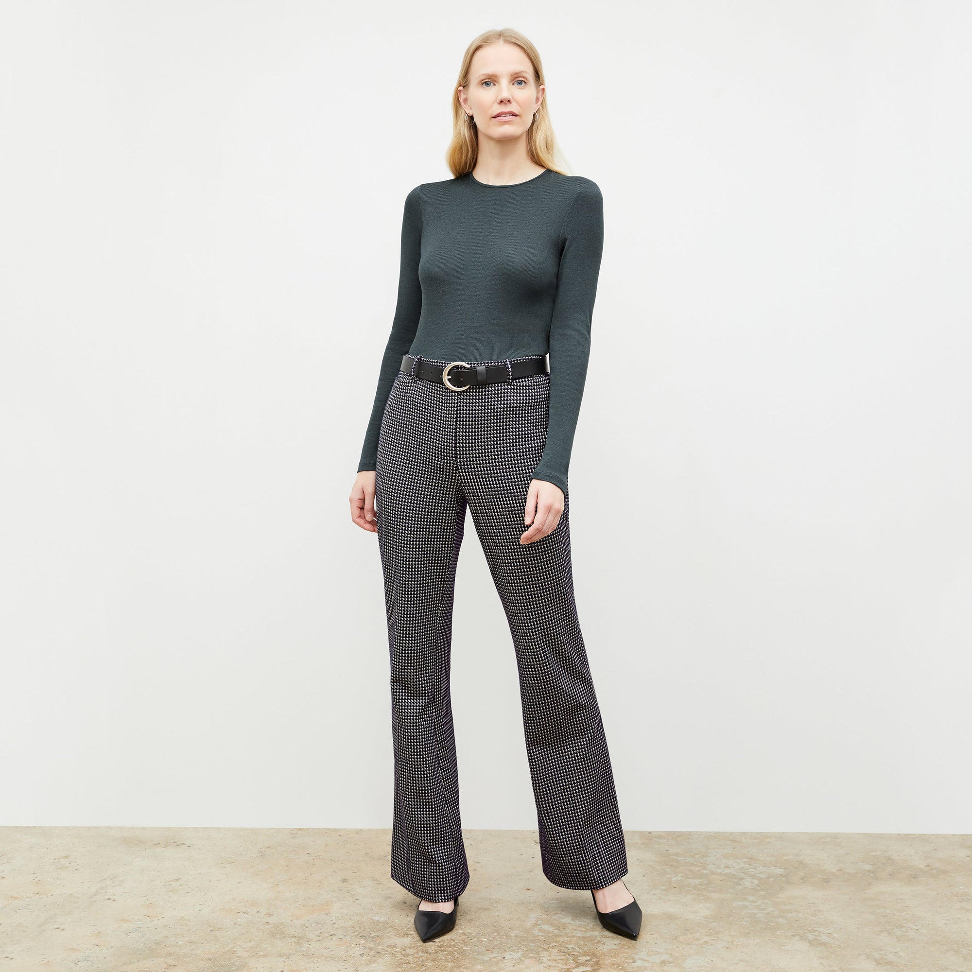 Front image of a woman wearing the horton pant in black and white houndstooth | Exclude