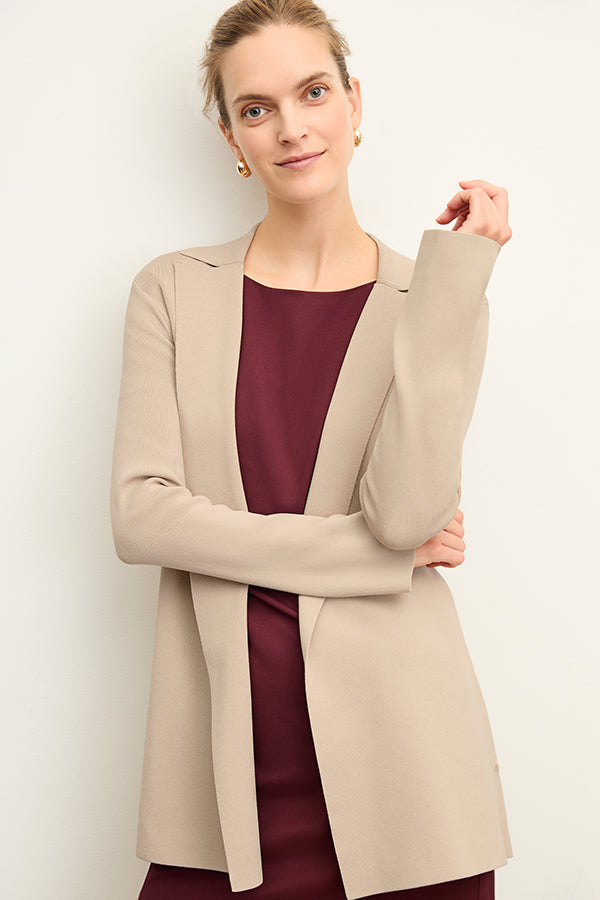 Front image of a woman standing wearing the Merritt jardigan in latte | Exclude