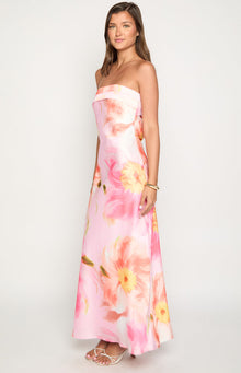 Side view of a pink floral print strapless maxi dress with a flowy silhouette