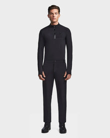 A man stands facing forward in the Rudsak KICO - 6523508 Black fitted long-sleeve zip-collar shirt with tailored pants and black shoes, set against a plain white background.