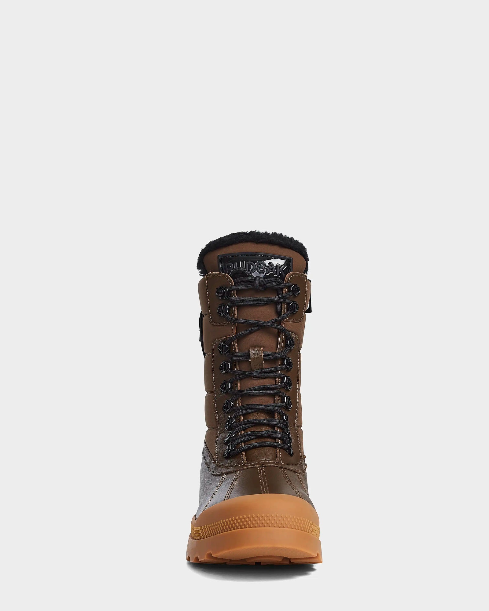 Front view of the Rudsak REAGAN - 6222500 Army mens winter boot, featuring brown leather, black laces with metal eyelets, a soft furry lining, and a tan rubber sole, shown against a plain white background.