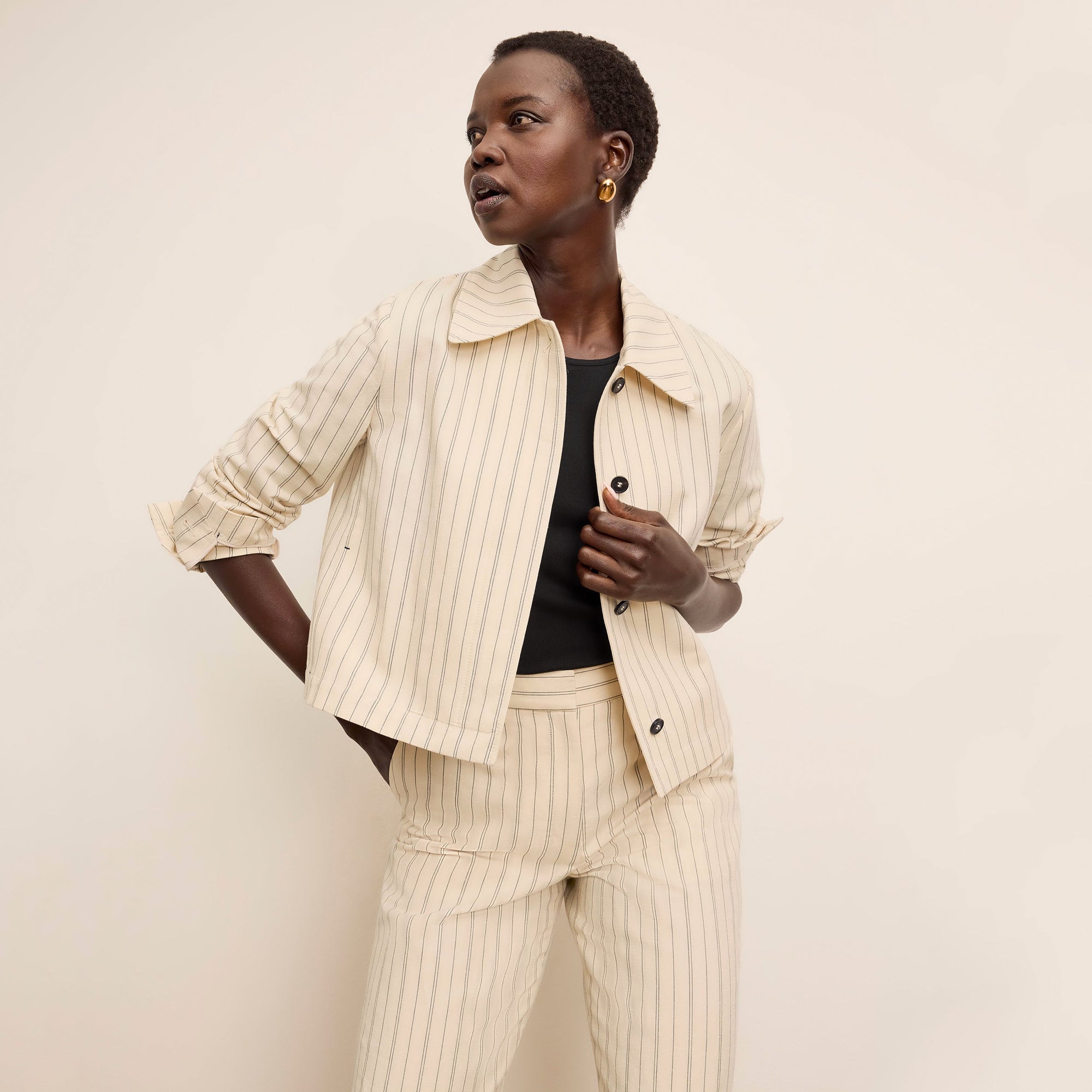 front image of a woman wearing the nicky jacket in linen stripe