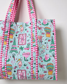 Close-up of the mint quilted tote showing colorful Las Vegas-themed illustrations, including cards, dice, drinks, hot-air balloons, and pink striped trim.