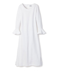 The Womens Pima Ophelia Nightgown by Petite Plume features flared cuffs, a round neckline, and a straight silhouette at midi length. Crafted from luxurious Peruvian Pima cotton, it showcases a subtle quilted effect in white jacquard against a plain white background.