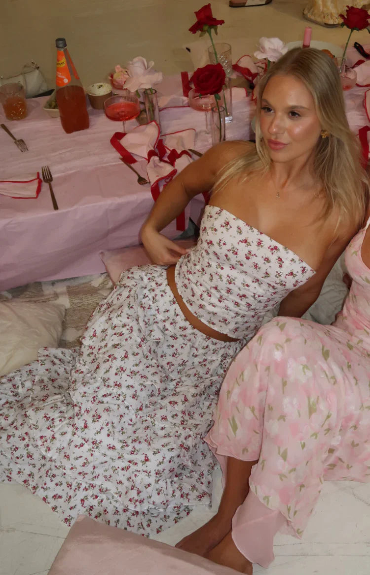 Side view of a white floral print maxi skirt with multiple tiers of ruffles
