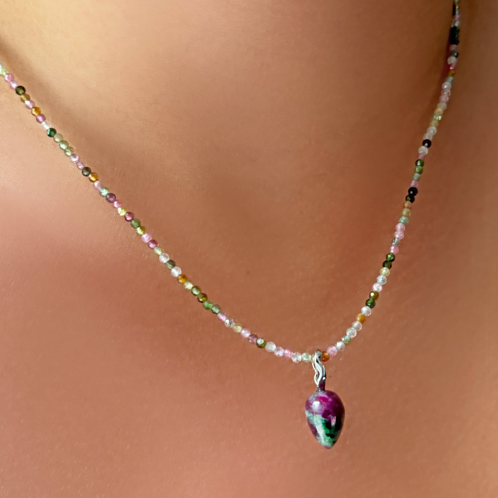 Ruby Zoisite Drop Charm and tourmaline slim gemstone necklace on the neck.