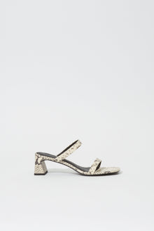 Cream and black snake-print sandal with ankle strap and chunky block heel.