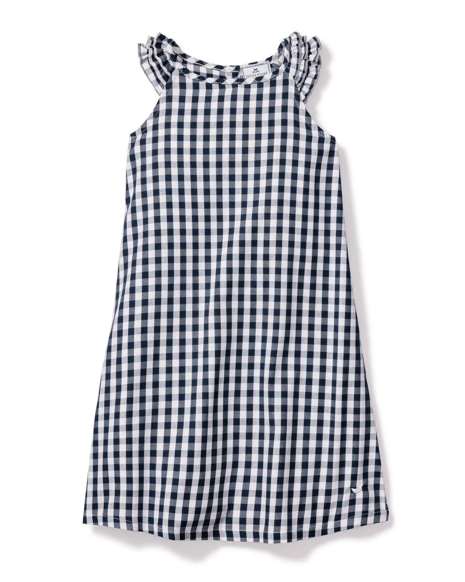 The Girls Twill Amelie Nightgown in Navy Gingham by Petite Plume is a sleeveless cotton dress with a navy and white check pattern. It has a round neck with subtle ruffle detailing for added charm.