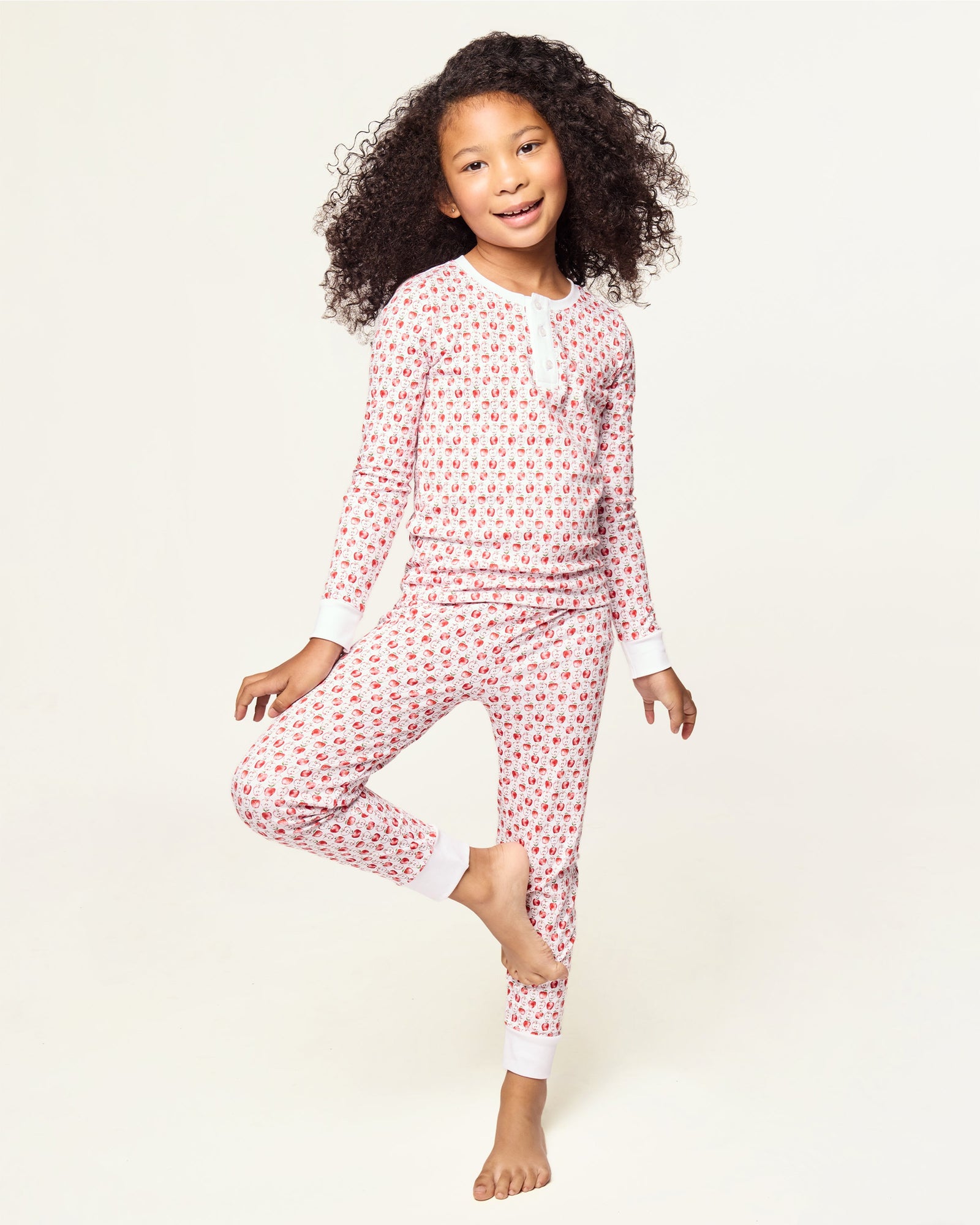 Kid's Pima Snug Fit Pajama Set in Autumn Orchards: two-piece set with long sleeves and pants, featuring a red flower pattern on a white background with solid white cuffs and neckline.