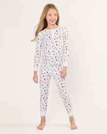 Kid's Pima Snug Fit Pajama Set in Merry Meow features a long-sleeve button-up top and matching pants with winter and holiday-themed prints of cats, trees, presents, and snowmen on a white background.