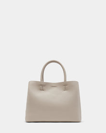 The Rudsak CATIRA S - 8325006 Vanilla is a beige womens pebble leather tote with two rounded handles, a removable shoulder strap, and a minimalist design—no visible logos or embellishments—shown against a plain white background.