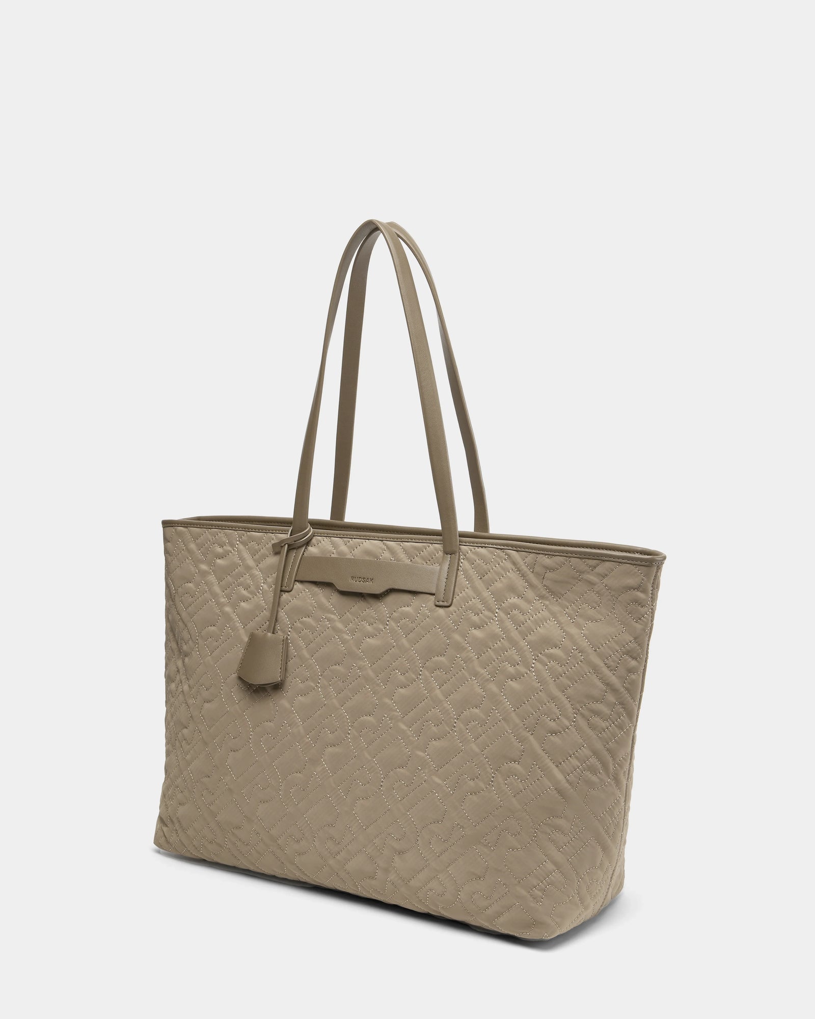 The Rudsak LIVORNO - L325007 Almond is a beige quilted monogram tote with double handles, a rectangular silhouette, decorative leather tag, and subtle stitched pattern for a minimalist luxury look.